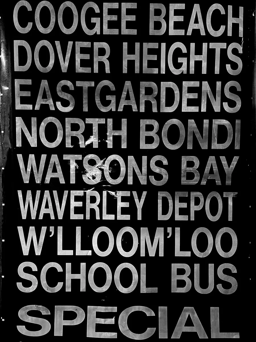 A black bus destination roll with white names: Coogee Beach, Dover Heights, Eastgardens, North Bondi, Watsons Bay.